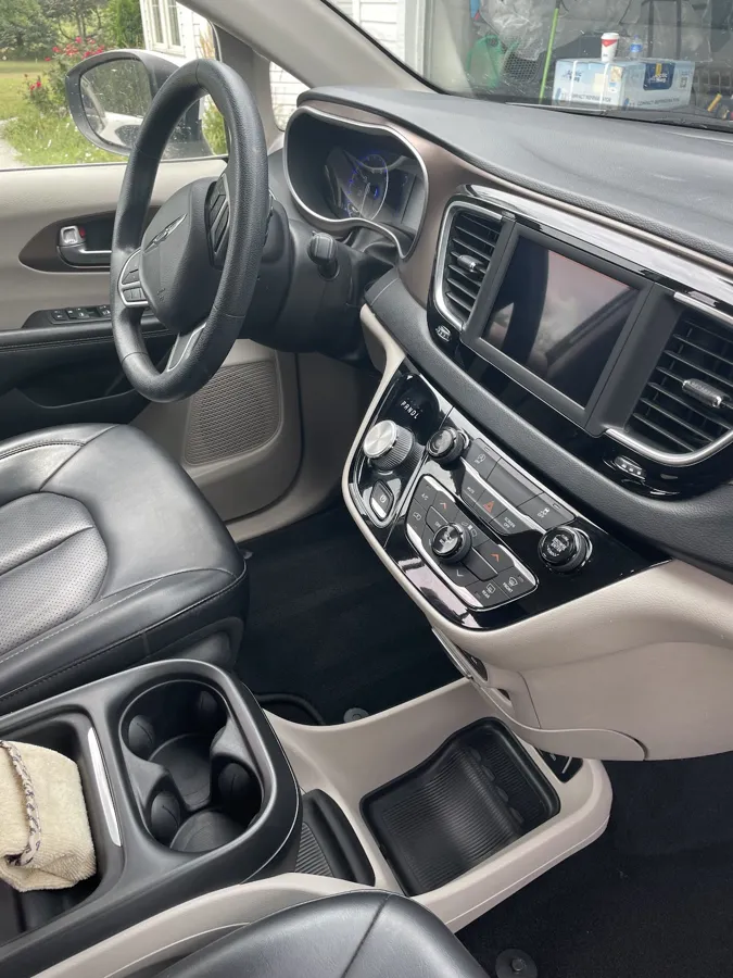 Clean dash, console, and cup holders in a minivan after a mobile detail in Lincoln, NE